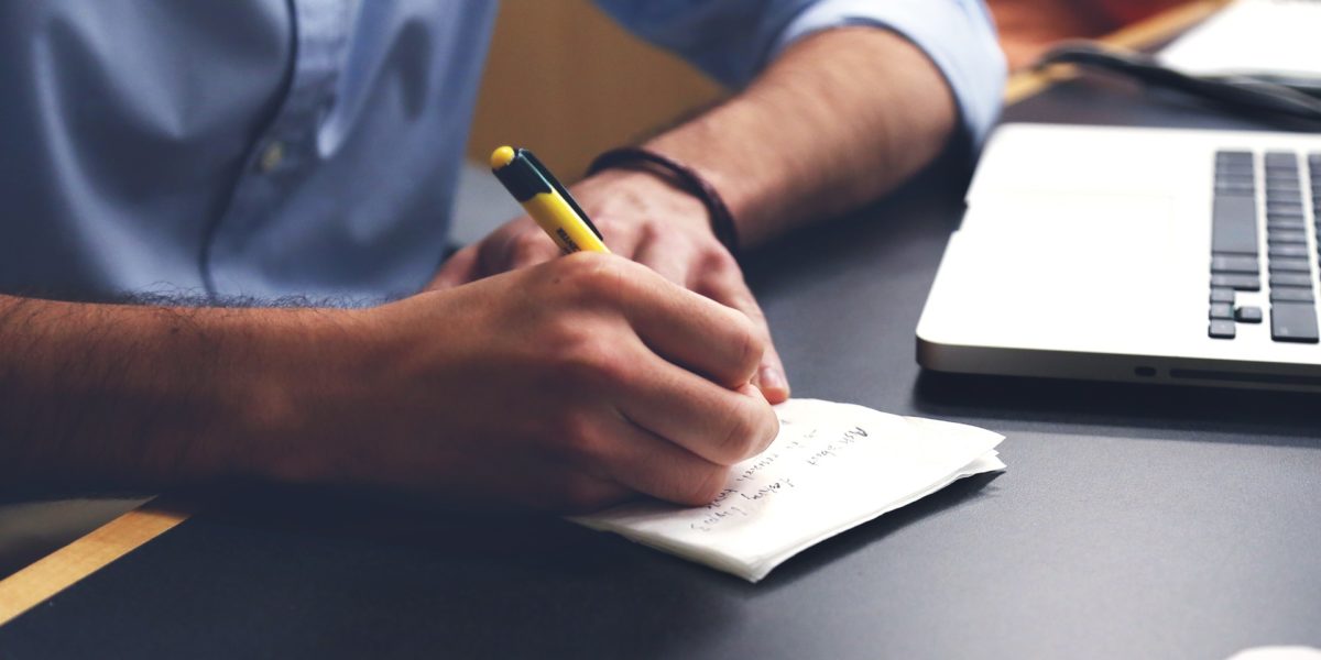 Man writing down notes